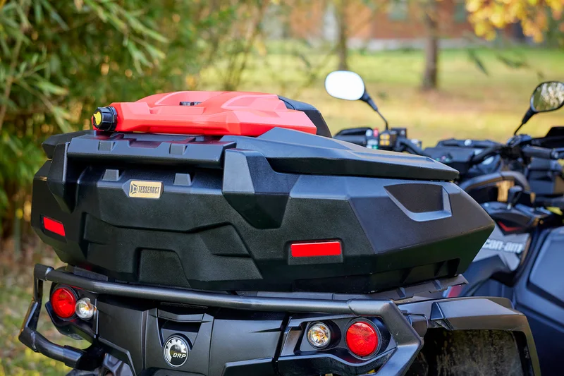 A cargo box and fuel can installed on a Can-Am ATV