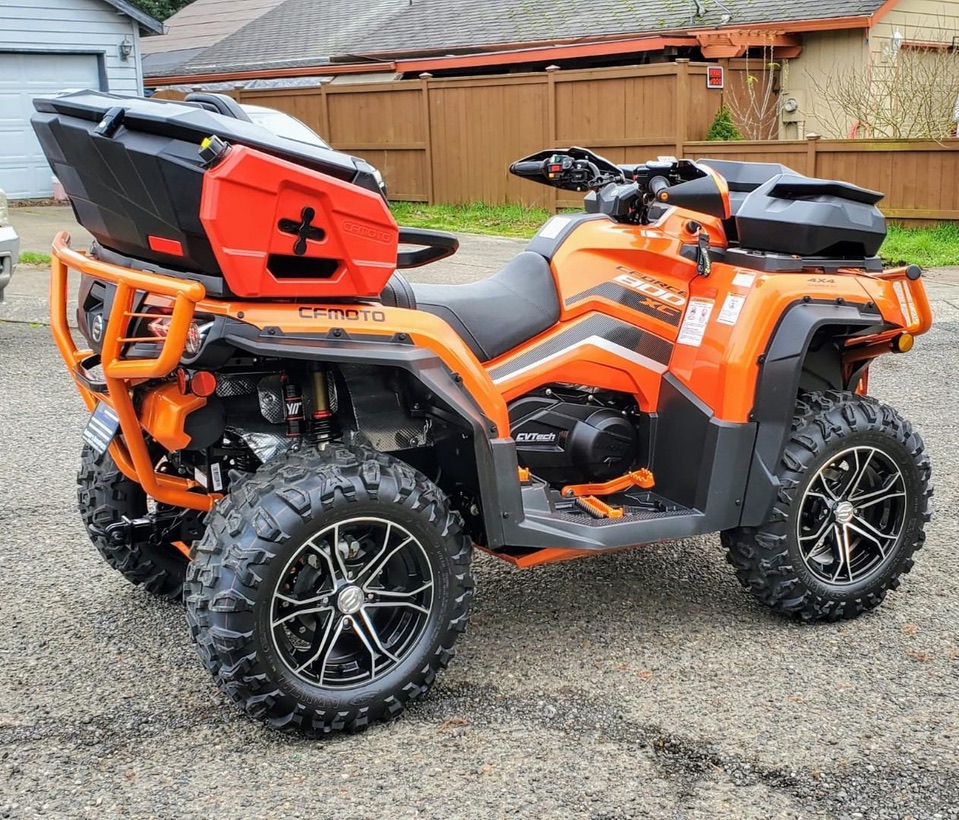 Red fuel can installed beside a cargo box on an orange CFMOTO ATV